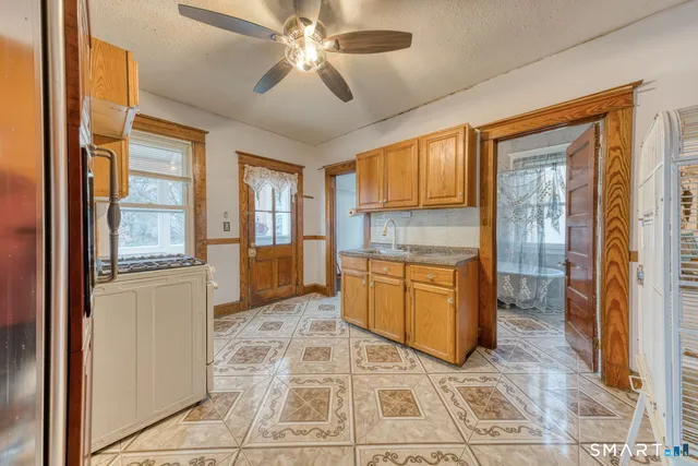 a bathroom with a tub shower and sink