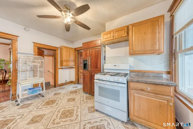 a kitchen with stainless steel appliances granite countertop a stove and a refrigerator