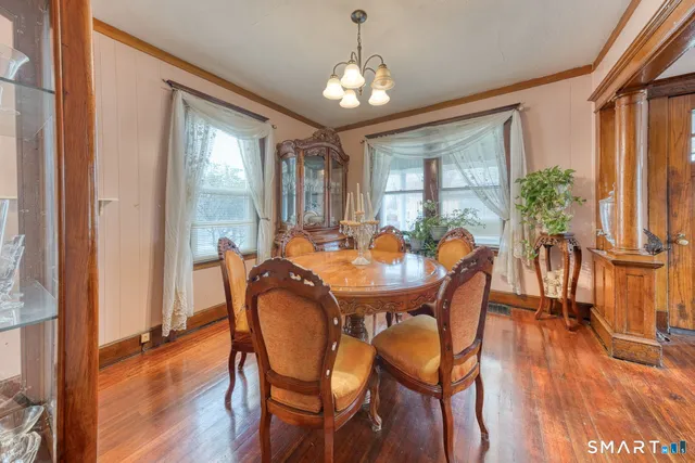 a view of a dining room with furniture window and wooden floor