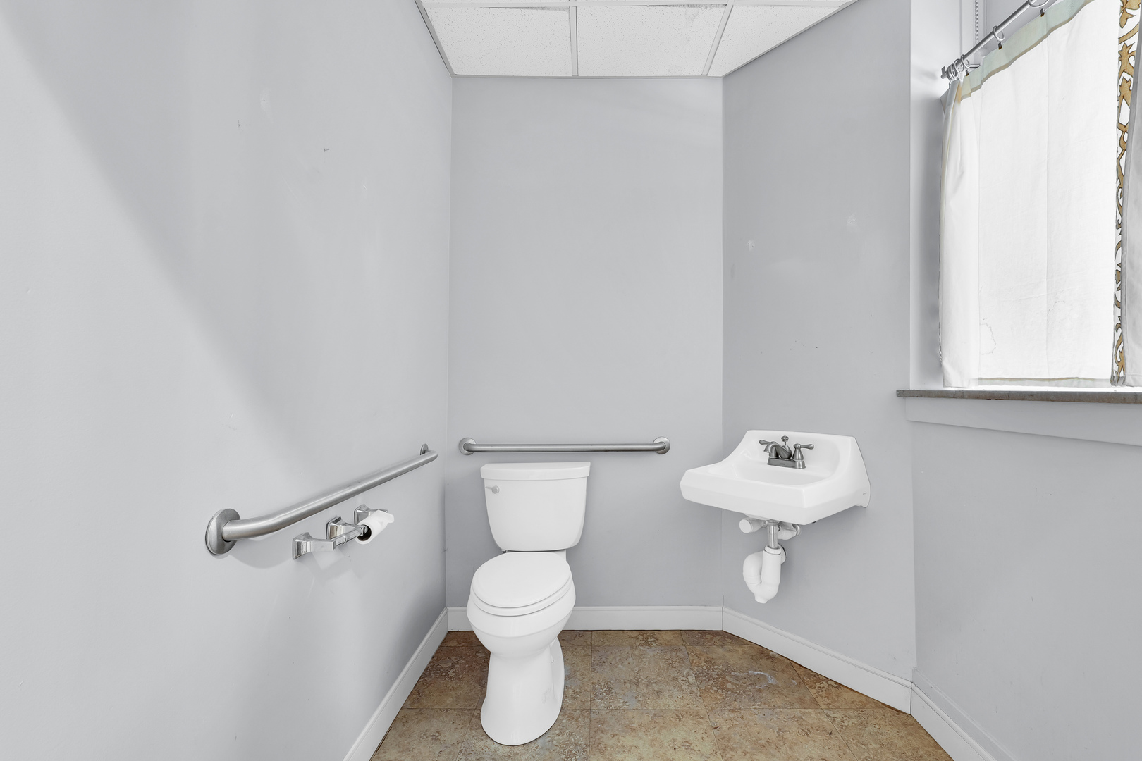 41 East University Avenue Champaign, IL 61820 - Photo 14 of 83 a white toilet sitting next to a bathroom sink