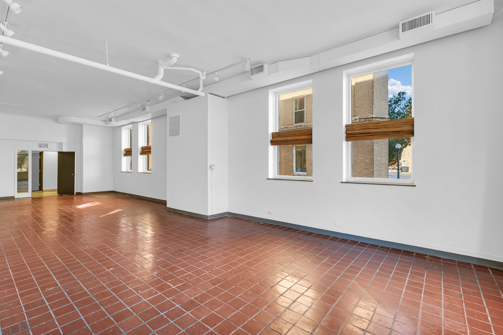 41 East University Avenue Champaign, IL 61820 - Photo 20 of 83 a view of an empty room with a window and wooden floor