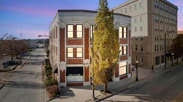 a front view of a building with a garden