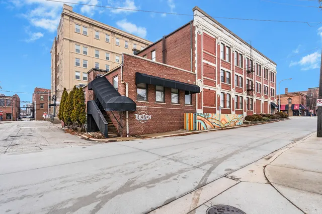 a bathroom with a granite countertop sink toilet and mirror