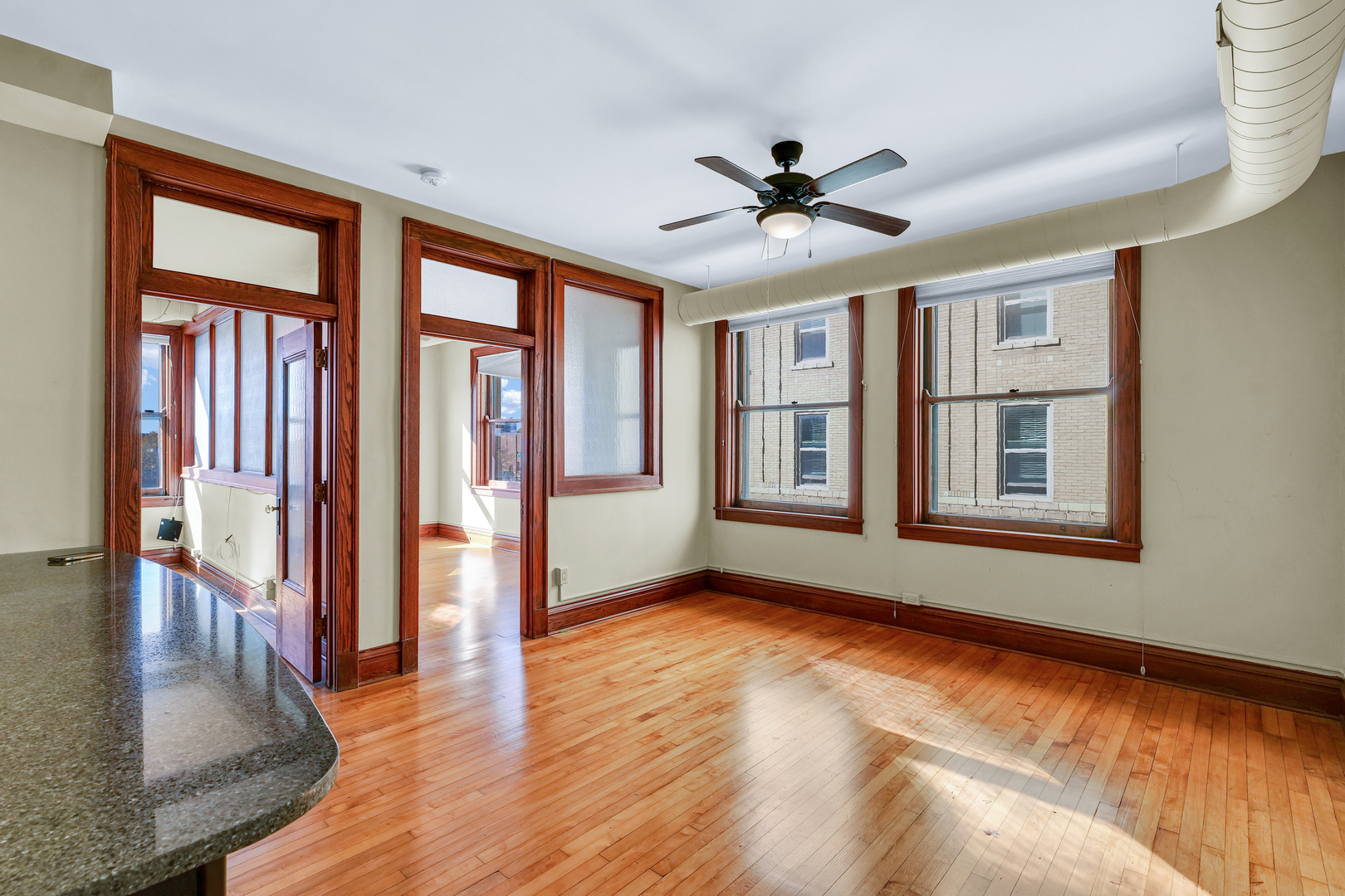 41 East University Avenue Champaign, IL 61820 - Photo 29 of 83 a view of an empty room with window and wooden floor