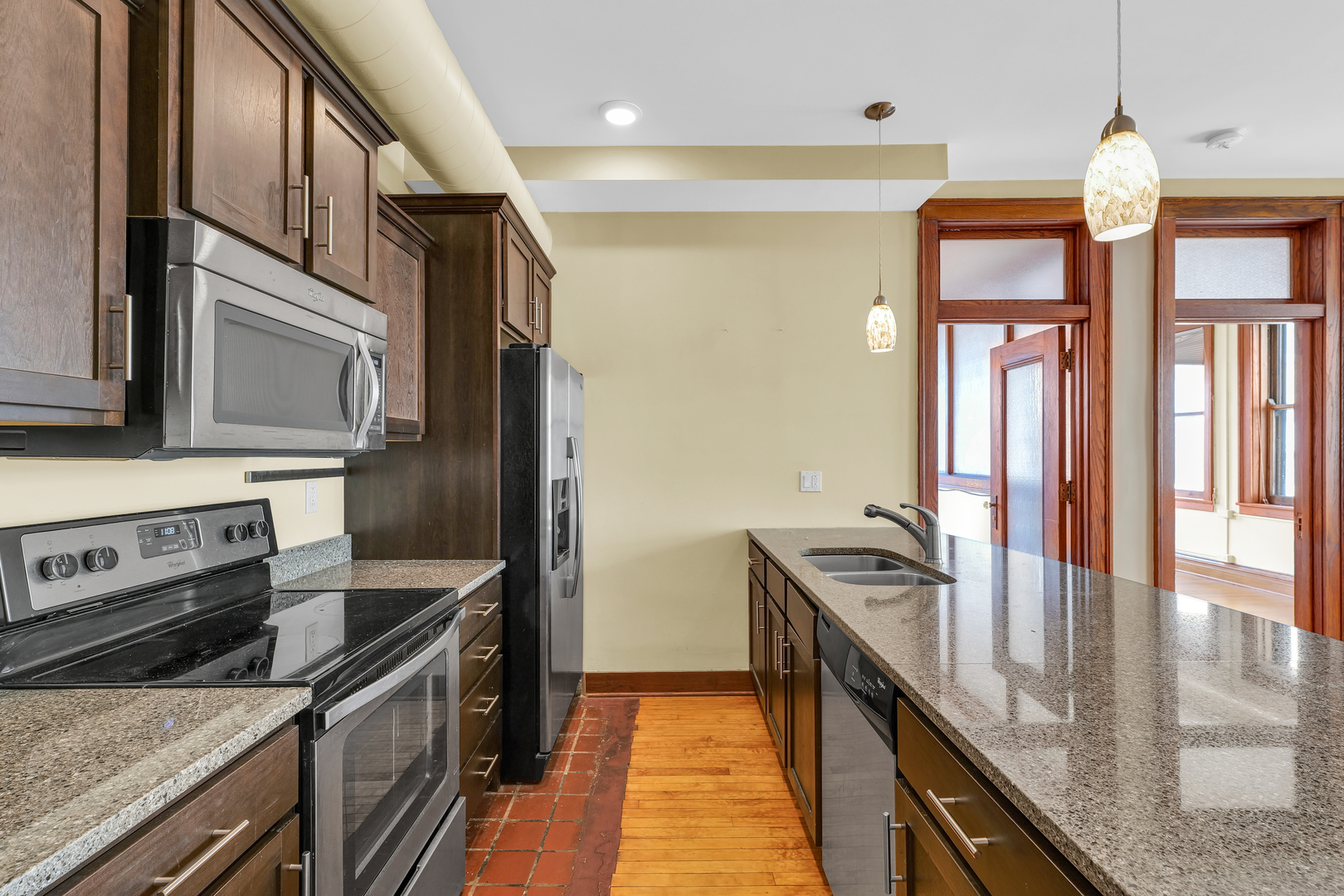 41 East University Avenue Champaign, IL 61820 - Photo 33 of 83 a kitchen with stainless steel appliances granite countertop a stove and a refrigerator