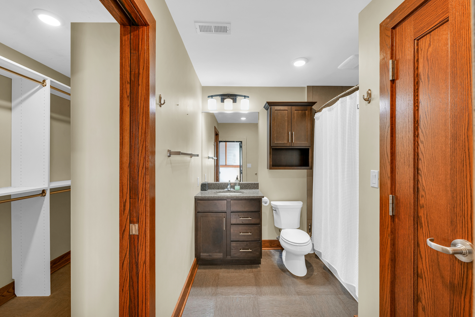 41 East University Avenue Champaign, IL 61820 - Photo 35 of 83 a bathroom with a toilet a sink and mirror