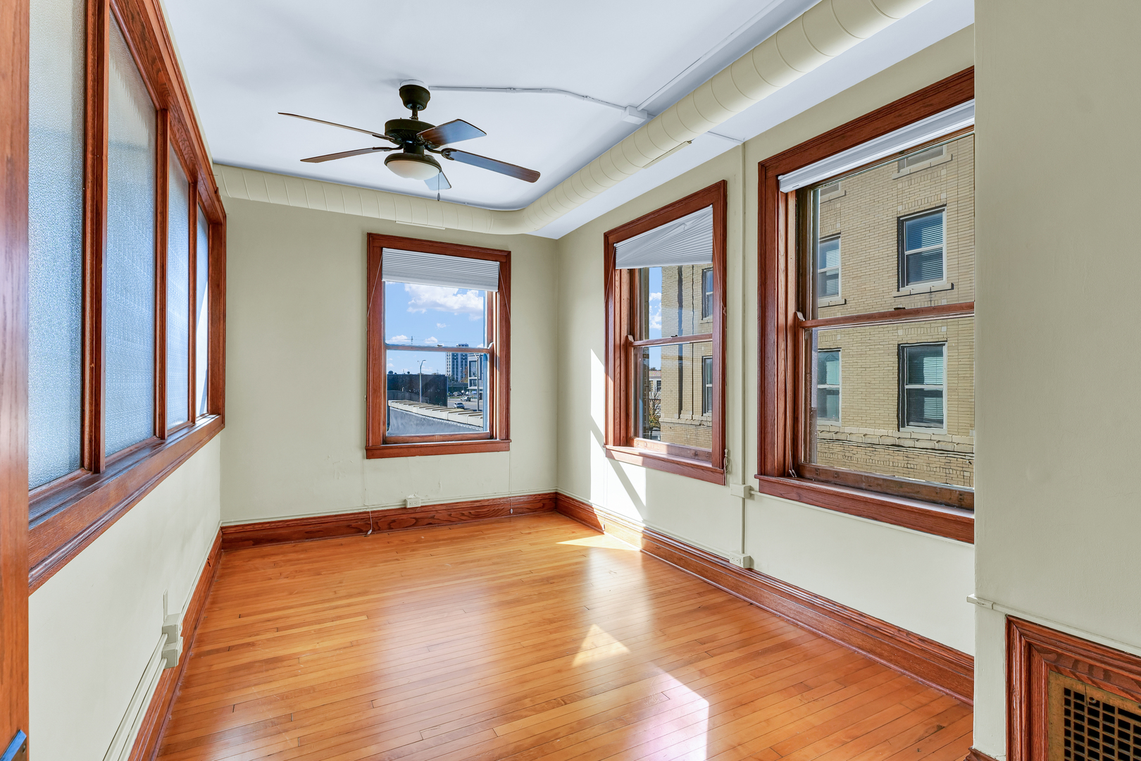 41 East University Avenue Champaign, IL 61820 - Photo 37 of 83 a view of an empty room with a window and wooden floor