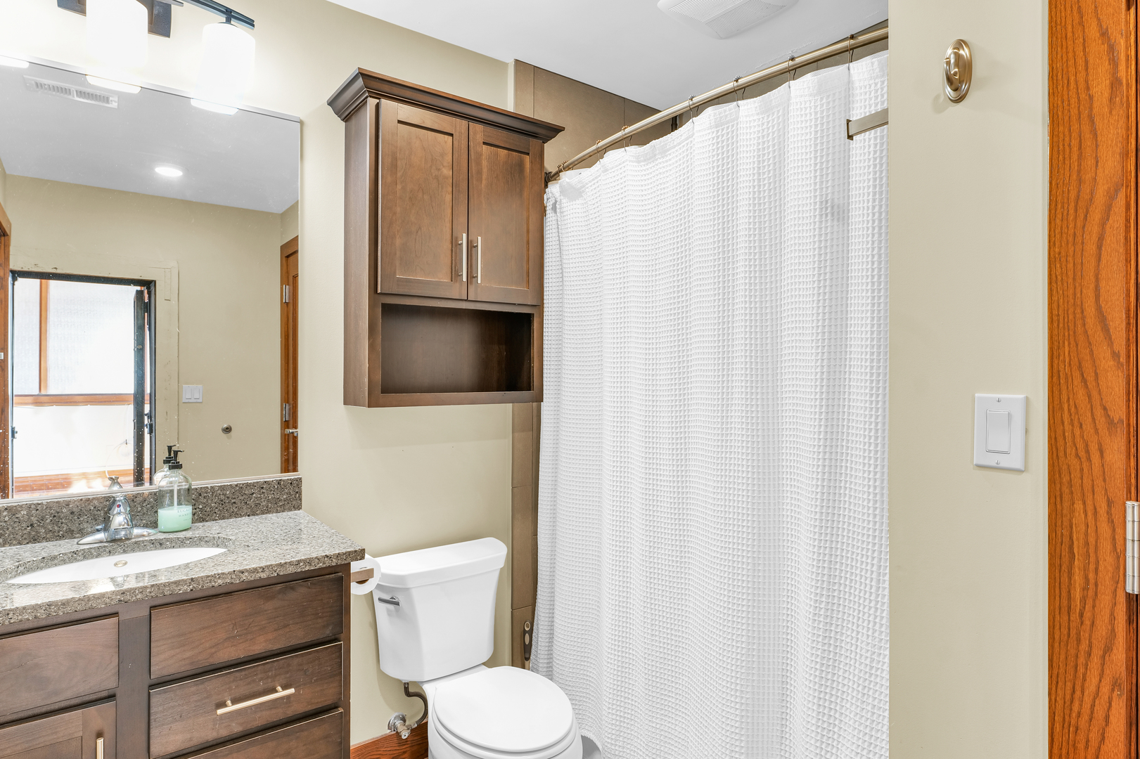 41 East University Avenue Champaign, IL 61820 - Photo 38 of 83 a bathroom with a granite countertop sink toilet and mirror