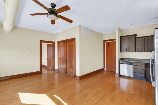 a spacious bedroom with a bed and a dresser