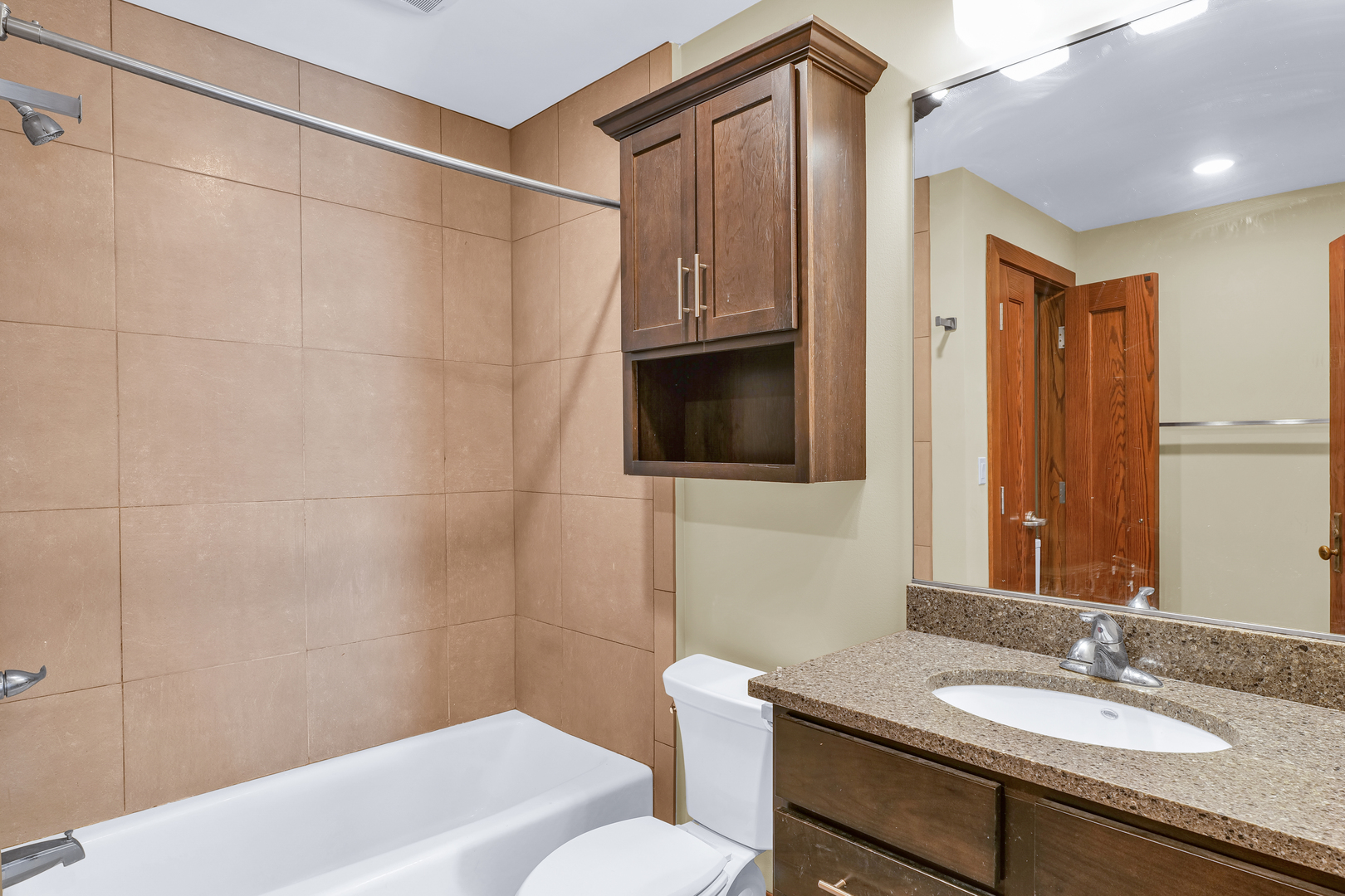 41 East University Avenue Champaign, IL 61820 - Photo 44 of 83 a bathroom with a sink a toilet and shower