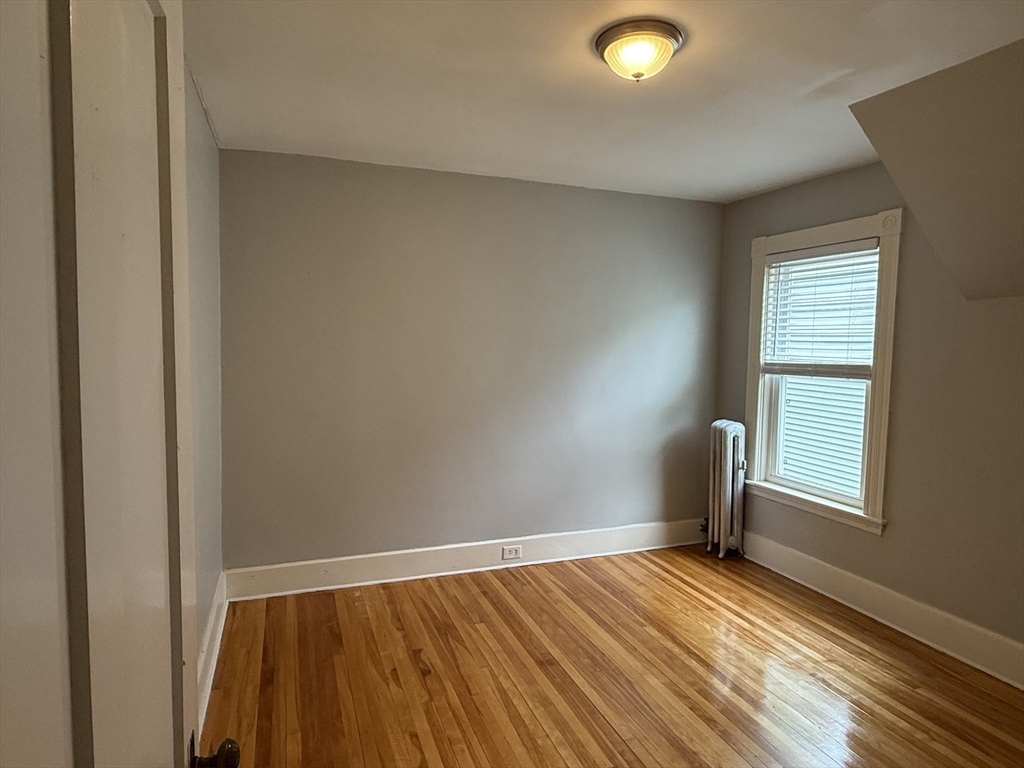 5 Arbor Vitae Street, Unit 2 Worcester, MA 01603 - Photo 9 of 12 a view of empty room with wooden floor and fan