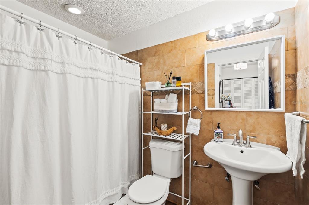 3802 Cortez Circle, Unit C Tampa, FL 33614 - Photo 14 of 24 a bathroom with a sink toilet and shower
