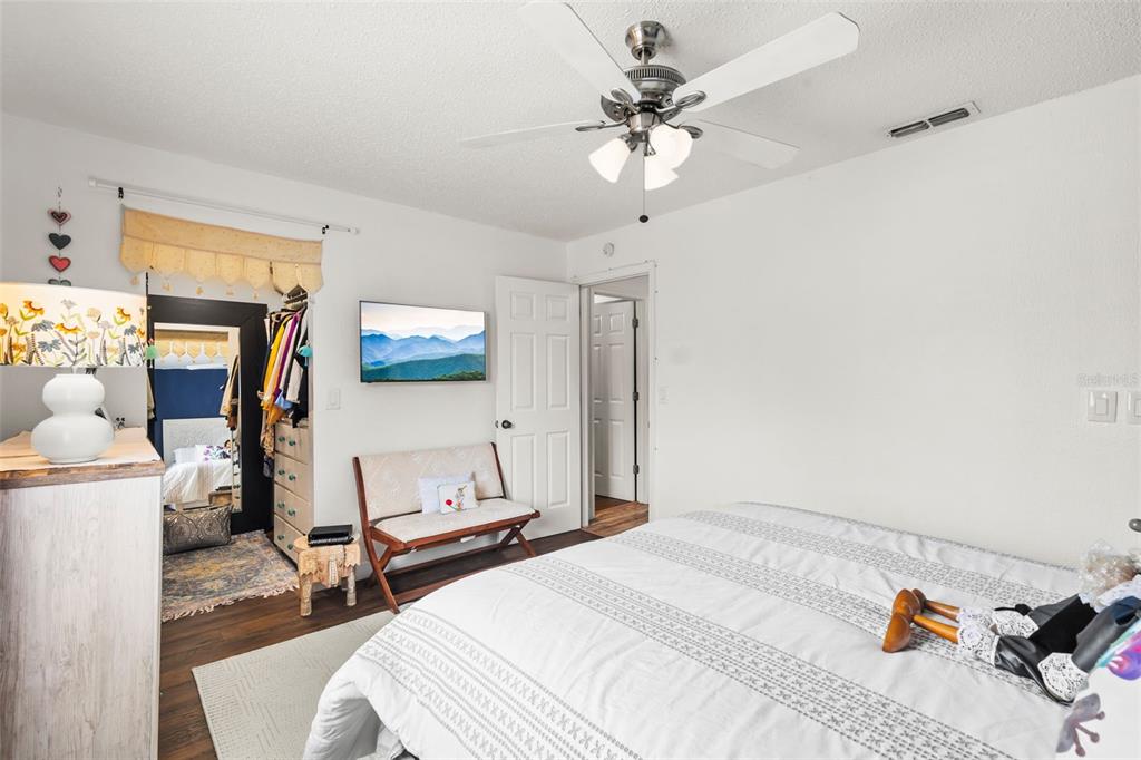 3802 Cortez Circle, Unit C Tampa, FL 33614 - Photo 16 of 24 a bedroom with a bed and a chandelier