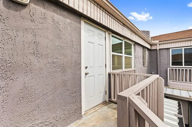 a view of front door and porch with wooden floor