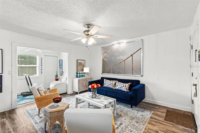 a living room with furniture and wooden floor