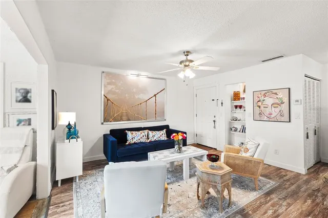 a living room with furniture and kitchen view