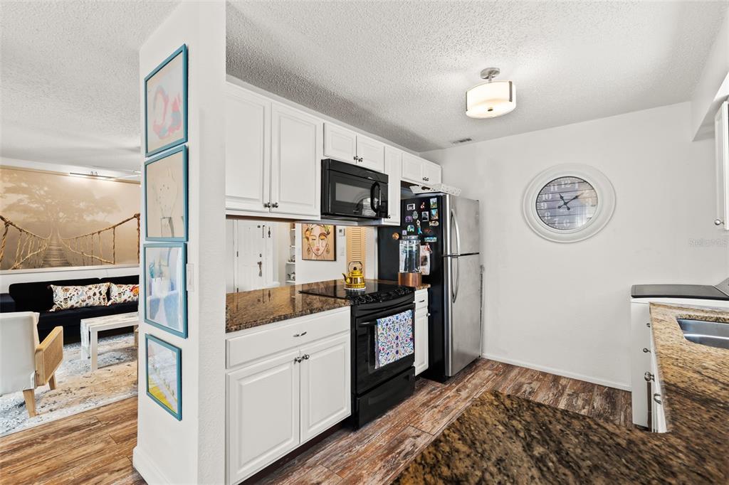 3802 Cortez Circle, Unit C Tampa, FL 33614 - Photo 10 of 24 a kitchen with stainless steel appliances granite countertop a refrigerator and a stove top oven
