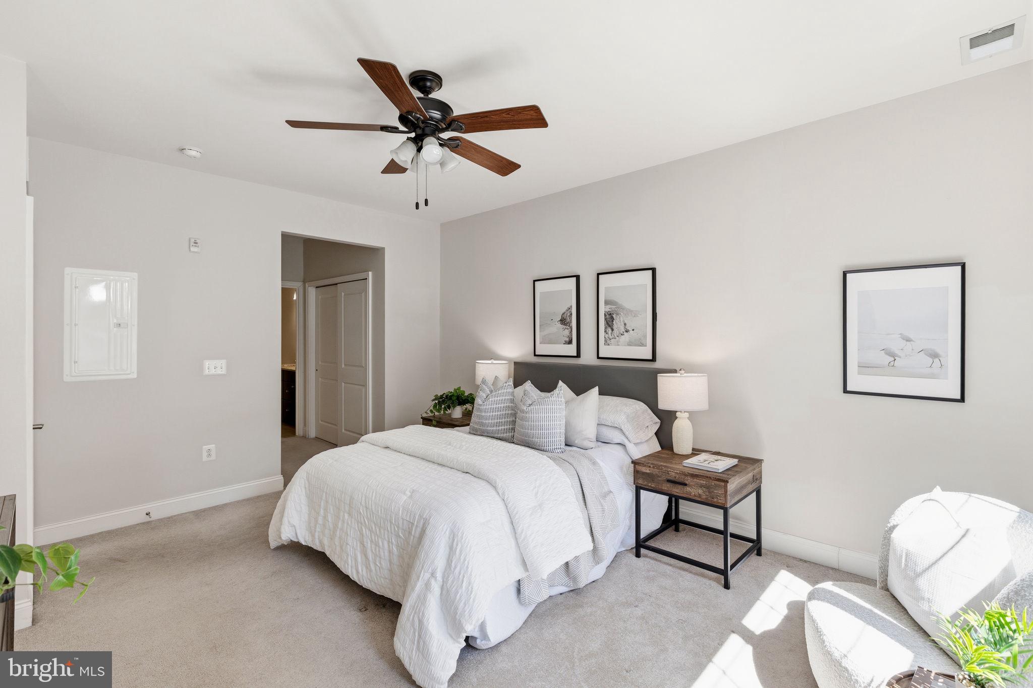 600 Commodore Court, Unit 2604 Philadelphia, PA 19146 - Photo 12 of 33 a bedroom with a bed and a chandelier