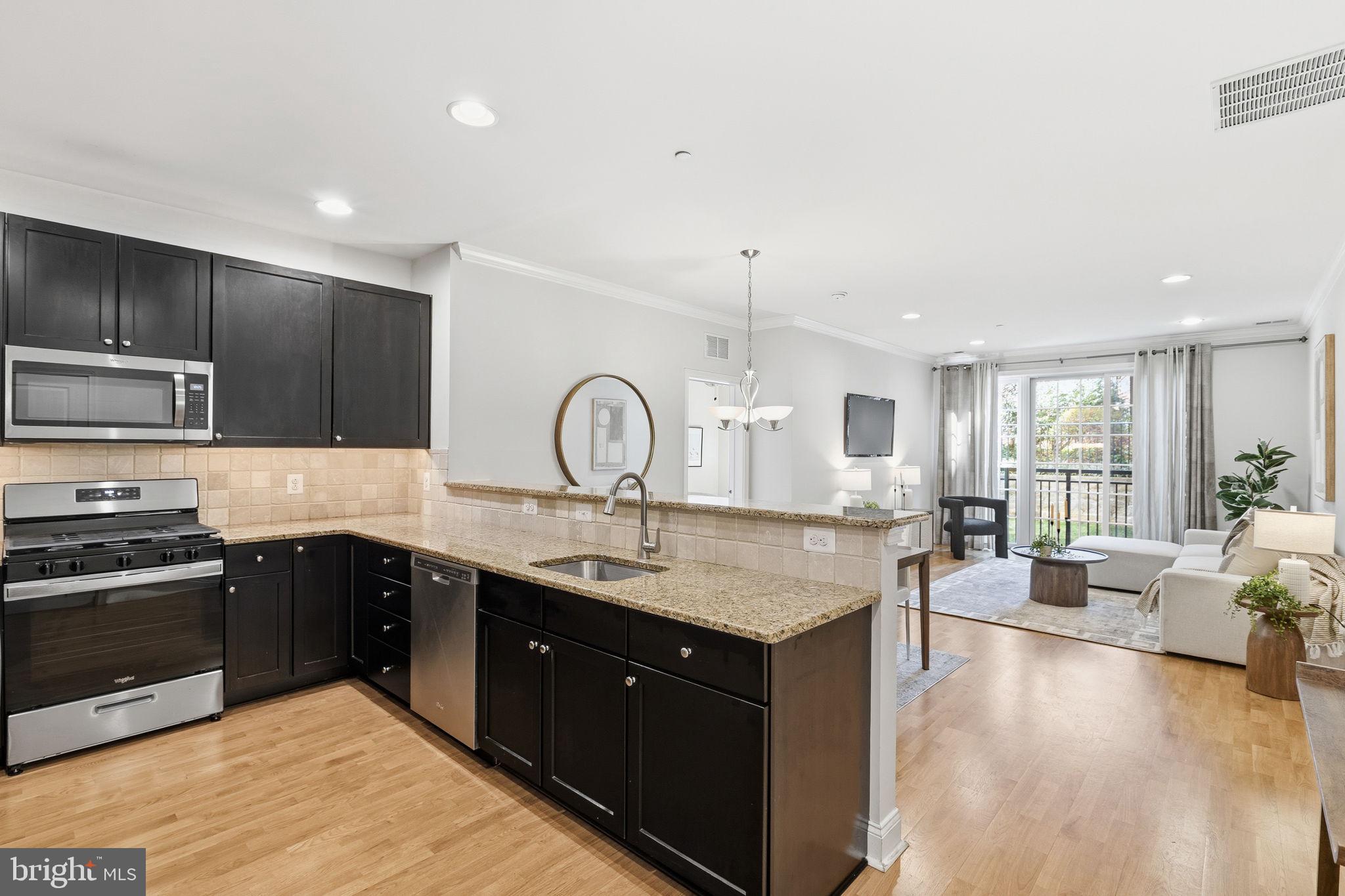 600 Commodore Court, Unit 2604 Philadelphia, PA 19146 - Photo 2 of 33 a large kitchen with kitchen island a sink stainless steel appliances and cabinets