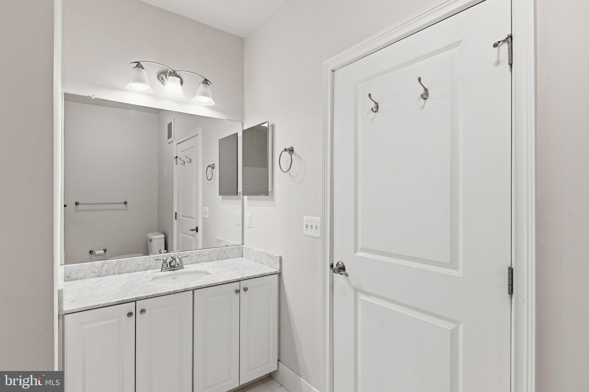 600 Commodore Court, Unit 2604 Philadelphia, PA 19146 - Photo 25 of 33 a bathroom with a double vanity sink mirror and shower
