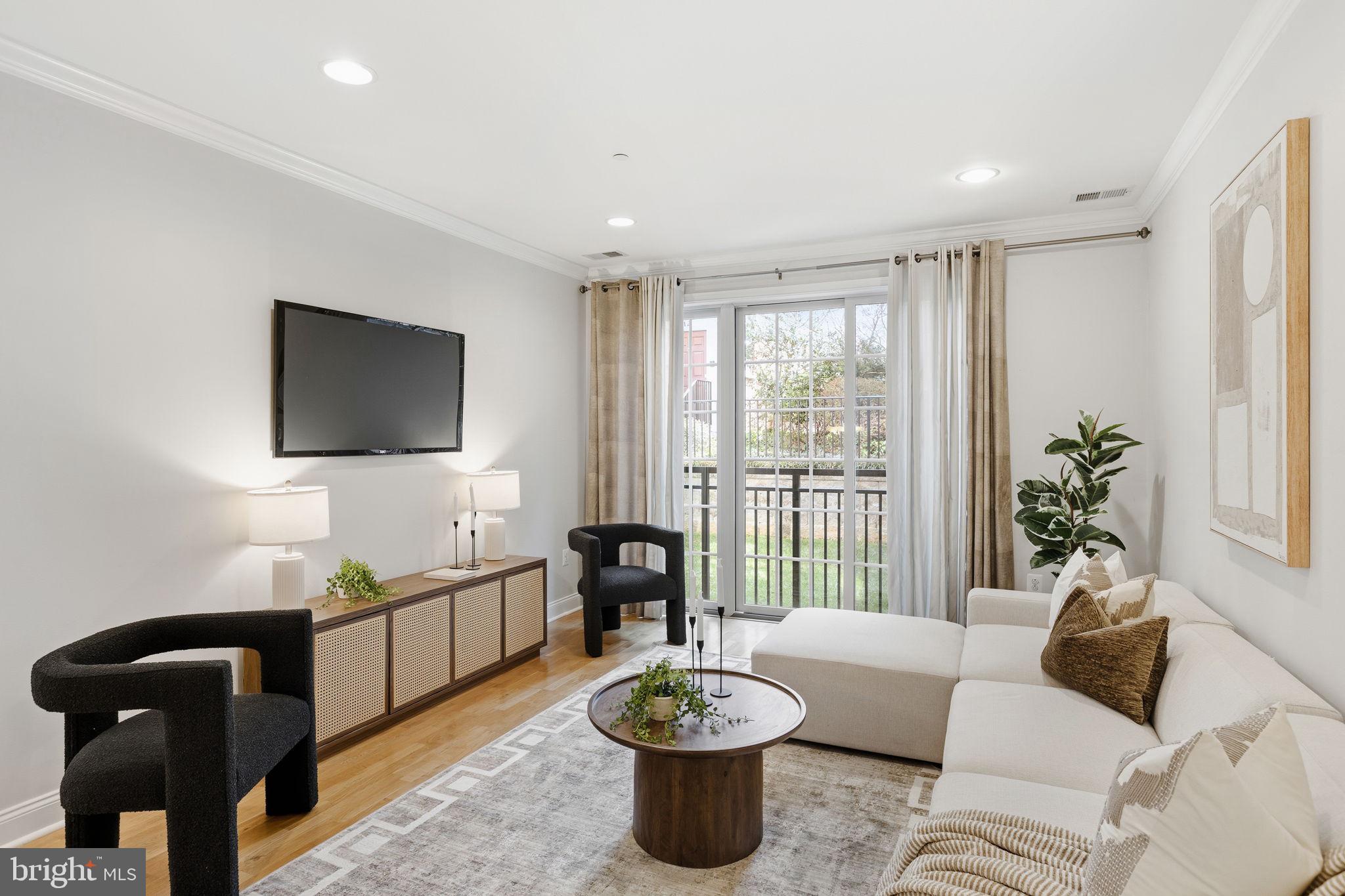 600 Commodore Court, Unit 2604 Philadelphia, PA 19146 - Photo 7 of 33 a living room with furniture a flat screen tv and a large window