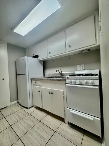 a utility room with sink washer and dryer