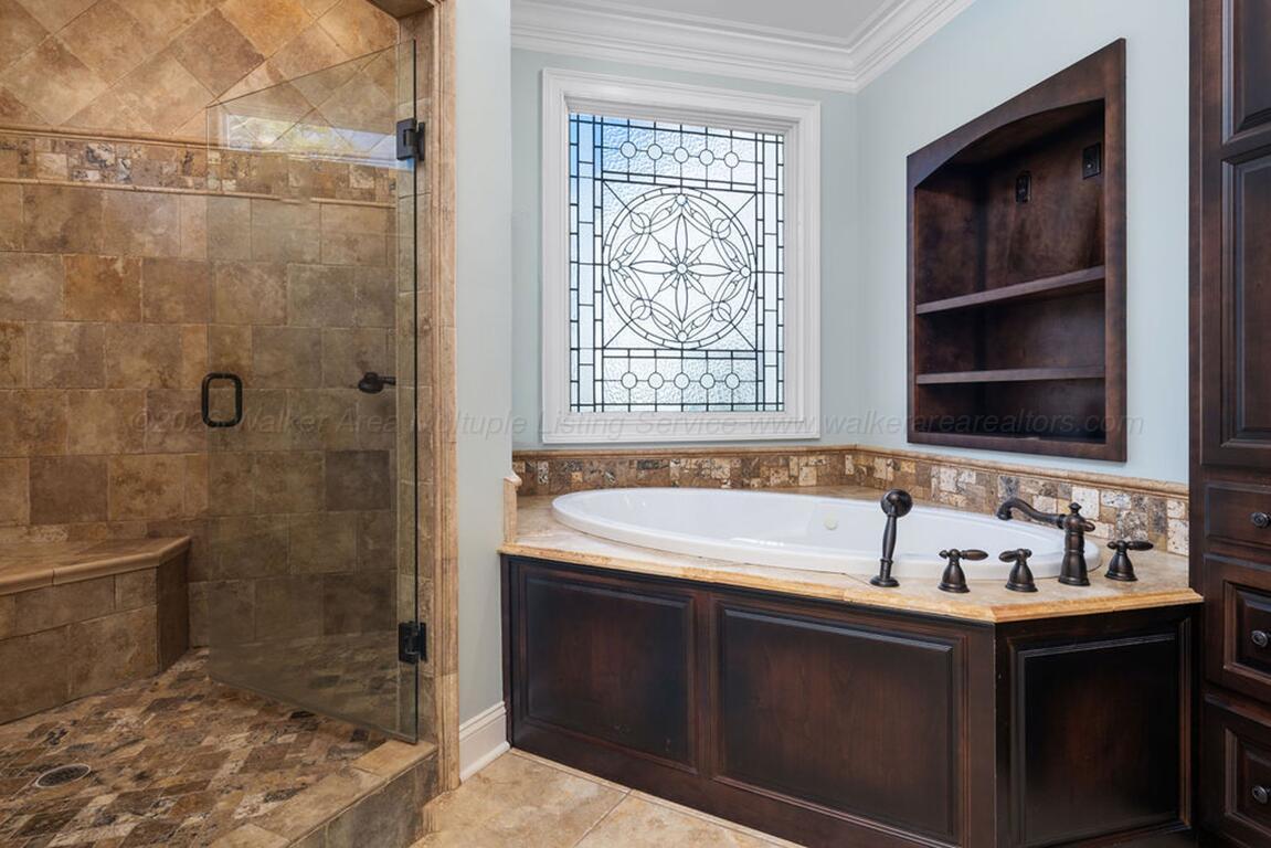 392 Baughn Road Jasper, AL 35503 - Photo 16 of 40 Primary bathroom with built-ins, double sinks, walk-in shower and tub.