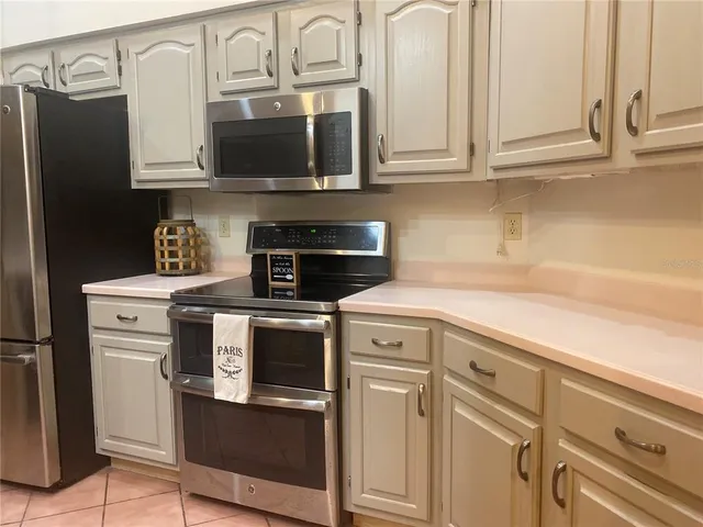 a kitchen with kitchen island a sink stainless steel appliances and cabinets