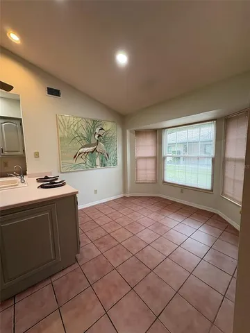 a view of a house with a yard and sitting area