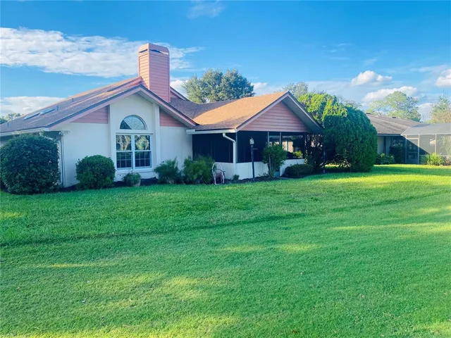 a kitchen with a refrigerator a sink and cabinets