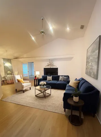 a living room with furniture and a lamp