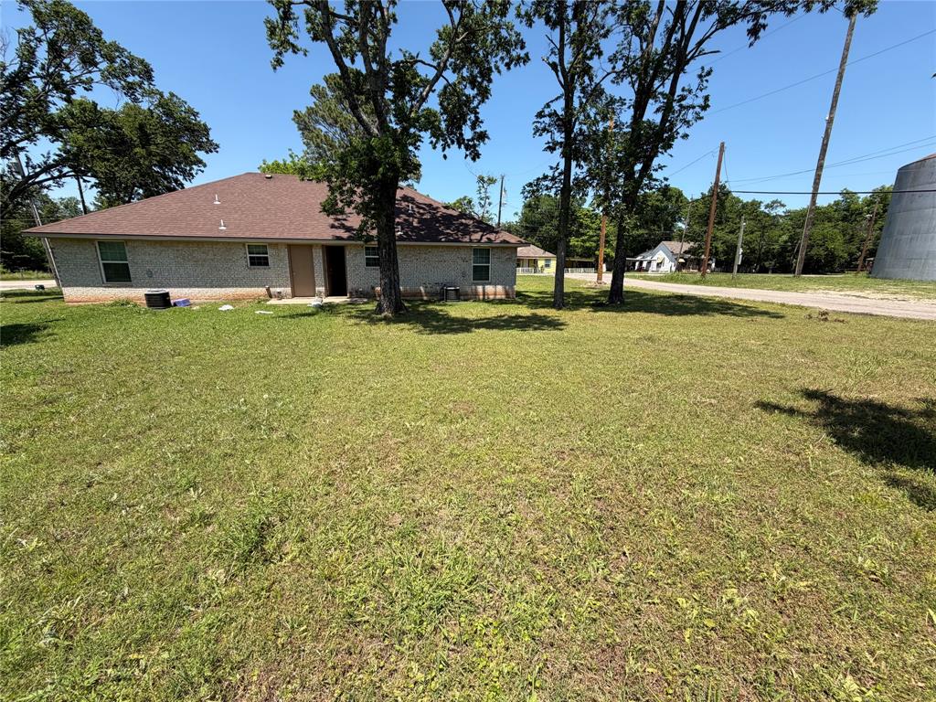 712 Seven Oaks Road, Unit 712 Bonham, TX 75418 - Photo 13 of 14 a front view of a house with a yard