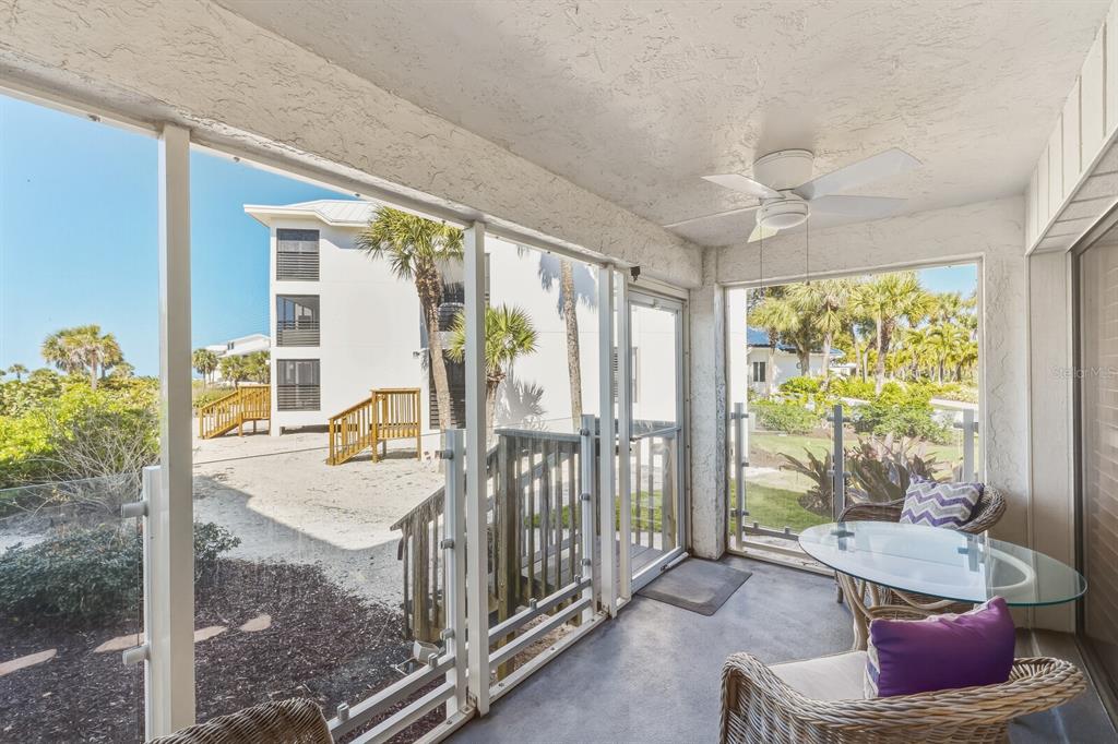 5000 Gasparilla Road, Unit DC107 Boca Grande, FL 33921 - Photo 12 of 30 a living room with furniture and a floor to ceiling window