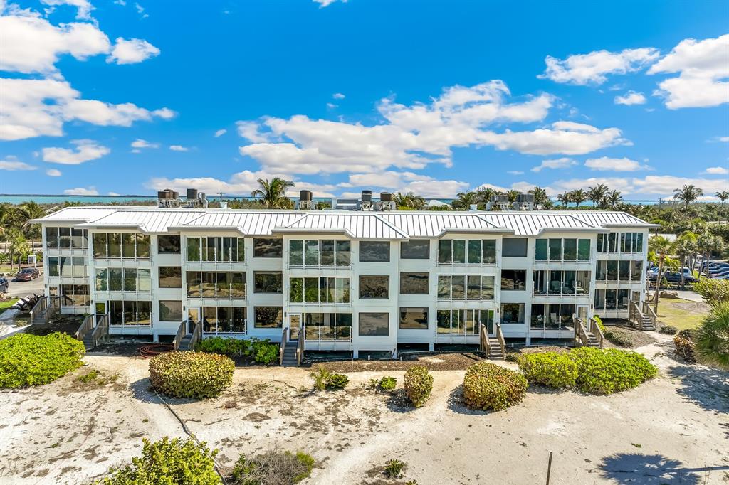 5000 Gasparilla Road, Unit DC107 Boca Grande, FL 33921 - Photo 16 of 30 a view of a large building next to a yard