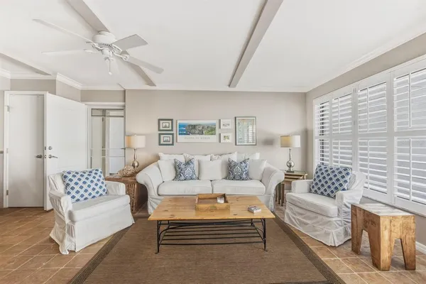 a living room with furniture a rug and a chandelier