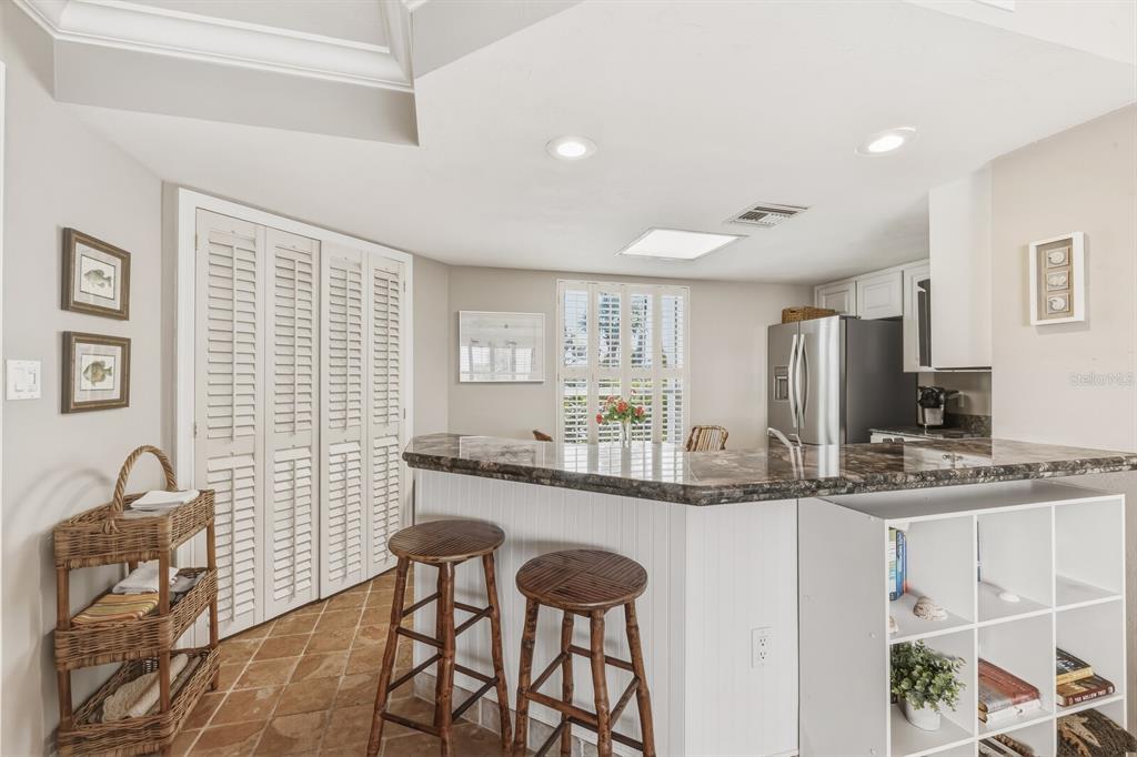 5000 Gasparilla Road, Unit DC107 Boca Grande, FL 33921 - Photo 5 of 30 a kitchen with stainless steel appliances granite countertop a sink and a stove