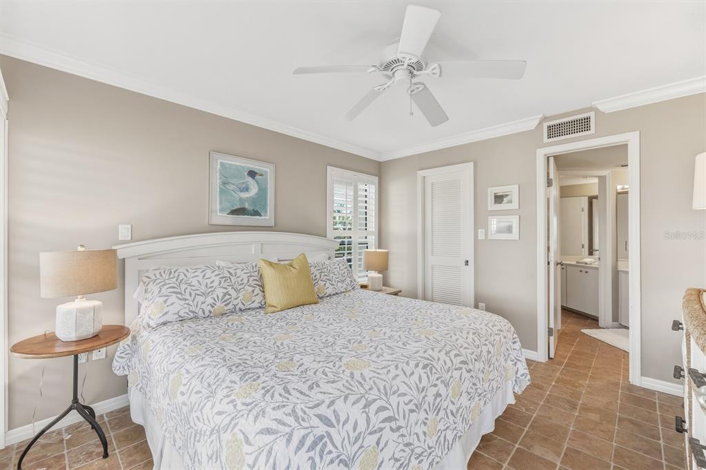 5000 Gasparilla Road, Unit DC107 Boca Grande, FL 33921 - Photo 8 of 30 a bedroom with a large bed and a chandelier