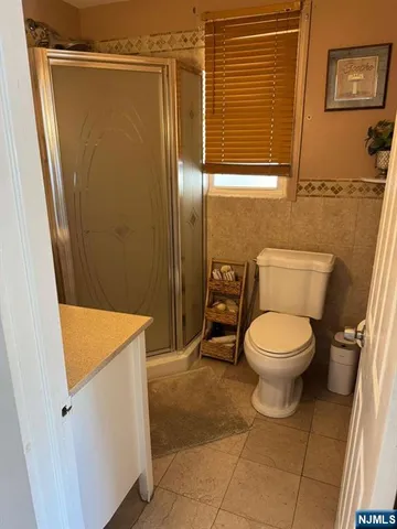 a bathroom with a toilet and a shower