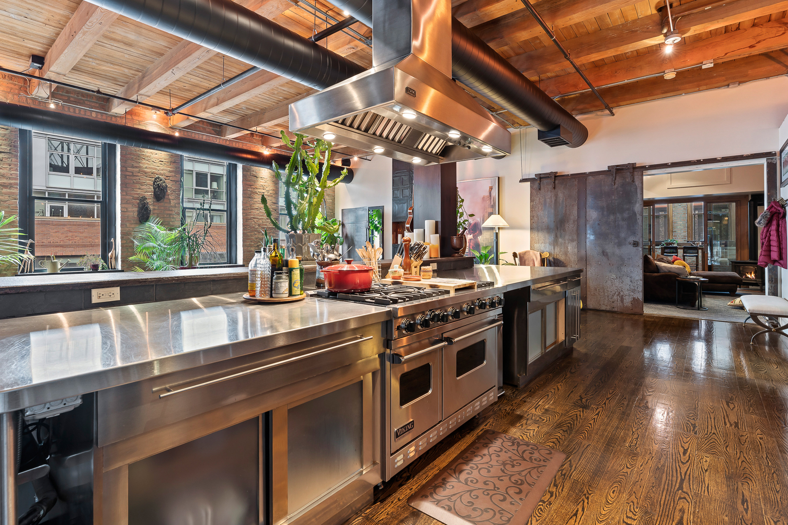 1101 West Lake Street, Unit 5E Chicago, IL 60607 - Photo 18 of 38 a kitchen with stainless steel appliances granite countertop a sink a stove and a wooden floors