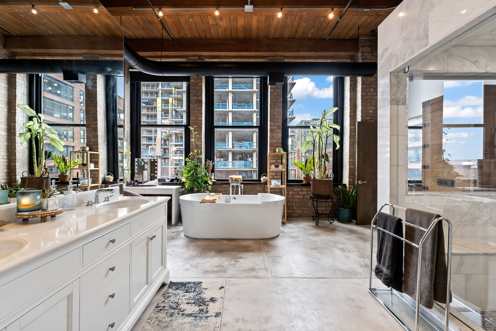 1101 West Lake Street, Unit 5E Chicago, IL 60607 - Photo 29 of 38 a large living room with a large window and chandelier