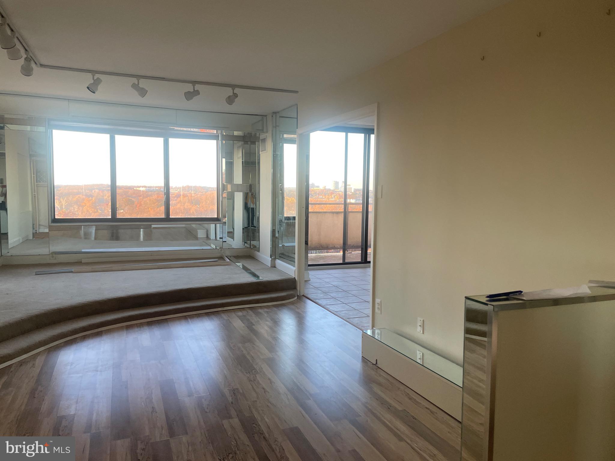 5225 Pooks Hill Road, Unit 1824N Bethesda, MD 20814 - Photo 7 of 50 a view of empty room with wooden floor and fan