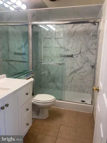 a bathroom with a toilet sink and shower