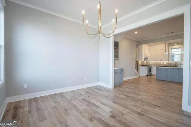 a view of a kitchen with a sink and wooden floor
