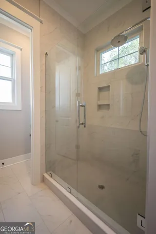 a bathroom with a glass shower door