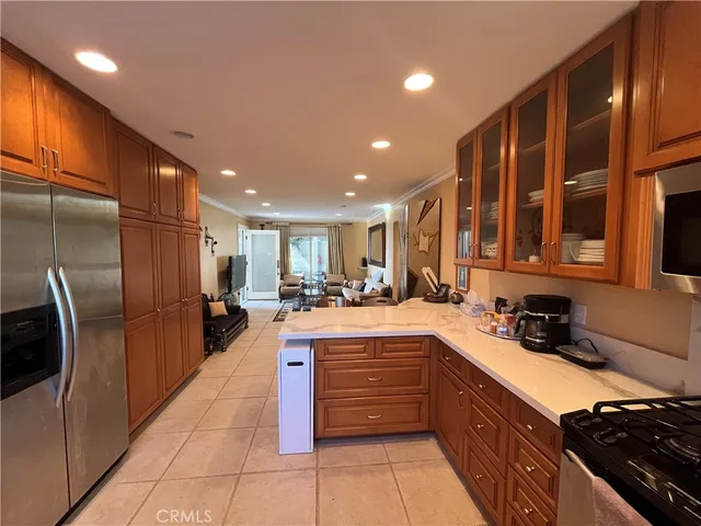 a kitchen with stainless steel appliances granite countertop a stove a sink and a microwave