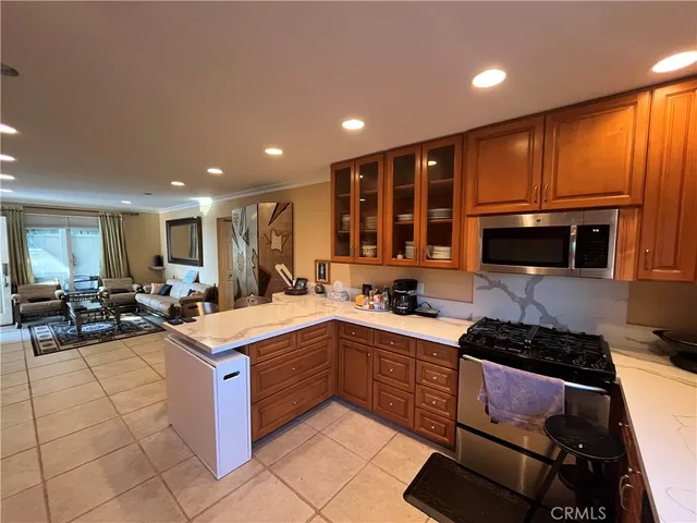 a kitchen with stainless steel appliances granite countertop sink stove and cabinets