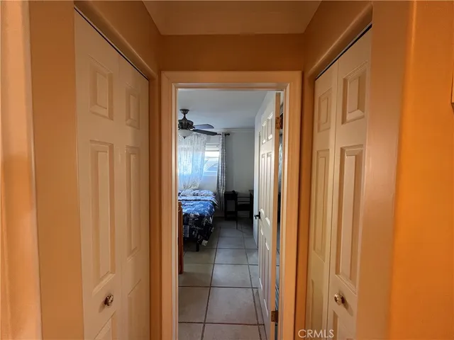 a bedroom with a bed and a mirror on the dresser