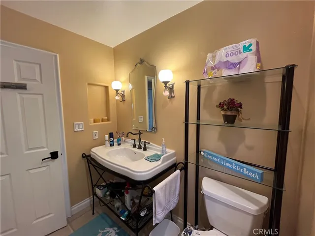 a bedroom with a bed and a mirror on a dresser