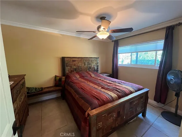 a bedroom with a bed and a mirror with a bookshelf