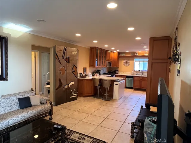 a kitchen with stainless steel appliances kitchen island granite countertop a refrigerator and a stove